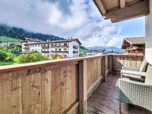 a balcony with a wooden railing with a bench at Apartment Schöser by Interhome in Weerberg