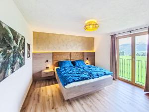 a bedroom with a bed and a large window at Apartment Schöser by Interhome in Weerberg