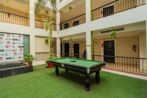 a pool table in the middle of a building at Kyriad Prestige Goa by Mastiff in Calangute