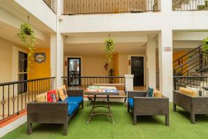 a patio with a table and chairs on a balcony at Kyriad Prestige Goa by Mastiff in Calangute