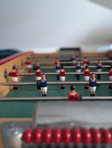 a group of dolls playing a game of billiard at Villa des Abers vue mer, GR34, piscine chauffée in Landéda