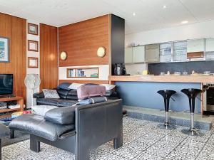 a living room with two leather chairs and a kitchen at Villa Villa Bikini by Interhome in Saint-Gingolph