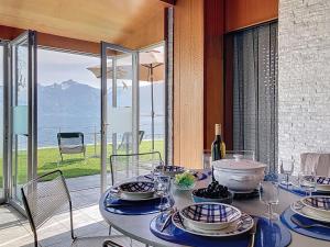 a dining room with a table with a view of the ocean at Villa Villa Bikini by Interhome in Saint-Gingolph +19 photos