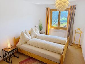 a living room with a couch and a window at Apartment Toissa A6 by Interhome in Salouf