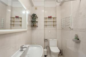 a white bathroom with a toilet and a sink at Almada Central by Homing in Almada +15 photos