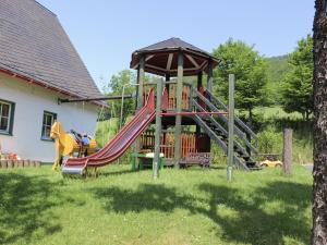 a playground with a slide and a gazebo at Rübenkämpers Ferienwohnungen in Schmallenberg
