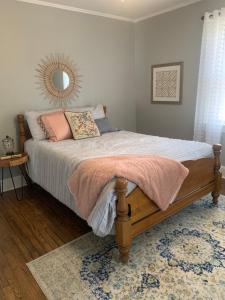 a bedroom with a bed with a mirror and a rug at Cozy Columbia Retreat in Columbia