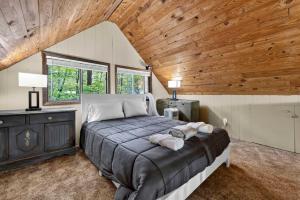 a bedroom with a bed and a wooden ceiling at DogFriendly wHot Tub Fire Pit Resort Access in Hedgesville