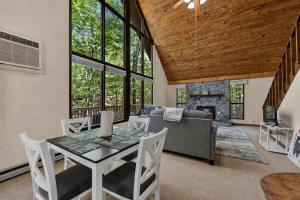 a dining room with a table and a fireplace at DogFriendly wHot Tub Fire Pit Resort Access in Hedgesville
