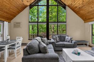 a living room with two couches and a table at DogFriendly wHot Tub Fire Pit Resort Access in Hedgesville +85 photos