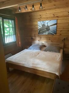 a bedroom with a bed in a wooden room at Ferienhaus 'am Eulennest' in Jabel
