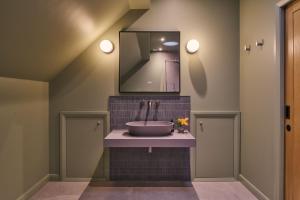ein Badezimmer mit Waschbecken und Spiegel in der Unterkunft Grain Loft in Trefeglwys