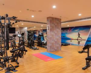 a gym with treadmills and exercise equipment at Royal Crown Muscat in Muscat