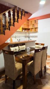 a dining room with a wooden table and chairs at Mayupata home in Cusco