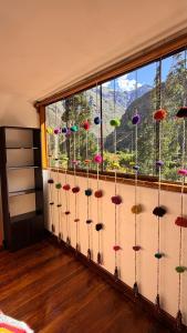 a room with a window filled with colorful flowers at Mayupata home in Cusco
