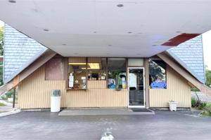 a store front with a large building with a door at Campus Inn by Hotel O Gainesville - University Area in Gainesville +21 photos