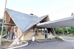 a building with a metal roof on the side of it at Campus Inn by Hotel O Gainesville - University Area in Gainesville