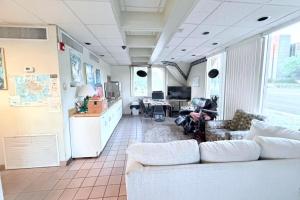 a living room with a couch and a table at Campus Inn by Hotel O Gainesville - University Area in Gainesville