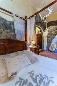 a bedroom with a bed with a stone wall at Frantoro - alloggio turistico - in Viterbo +48 photos