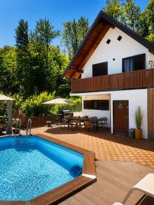 a house with a swimming pool in front of it at La Casa Kiara - Heated Pool, Jacuzzi & Forest View in Stubicke Toplice