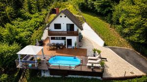 an overhead view of a house with a swimming pool at La Casa Kiara - Heated Pool, Jacuzzi & Forest View in Stubicke Toplice