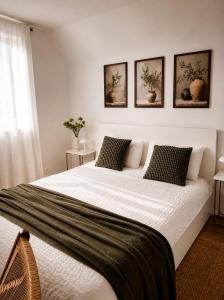a bedroom with a large bed with three pictures on the wall at La Casa Kiara - Heated Pool, Jacuzzi & Forest View in Stubicke Toplice +54 photos