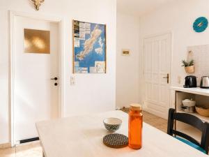 a kitchen with a table with a bottle on it at Casa Spartines in Votsi