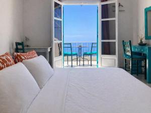 a bedroom with a bed and a view of the ocean at Casa Spartines in Votsi