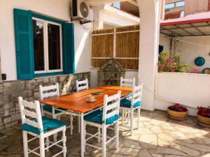 a wooden table and chairs on a patio at Casa Spartines in Votsi