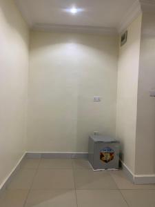 a room with a white wall and a box at Kris Courts in Ibadan