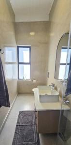 a bathroom with a sink and a mirror at Sky & Sea in St. Helena Bay +9 photos