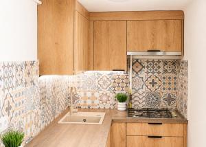 a kitchen with a sink and a stove top oven at Kwatery Fado in Częstochowa