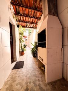 a hallway of a building with a pizza oven at Pousada Timbalada in Morro de São Paulo
