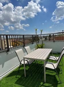 a wooden table and chairs on a balcony with a table at Catullo Loft Near Verona in Dossobuono +19 photos
