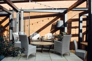 a patio with wicker chairs and a table on a patio at The White Hart in Ampthill