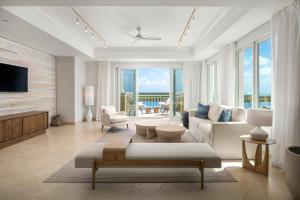 a living room with a couch and a tv at Blue Haven Resort- All Inclusive in Providenciales