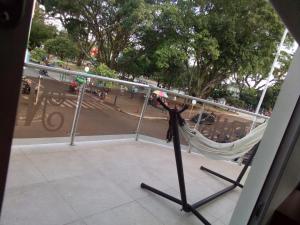 a hammock on a balcony with a view of a street at Hotel Nayarith in Acacías +3 photos