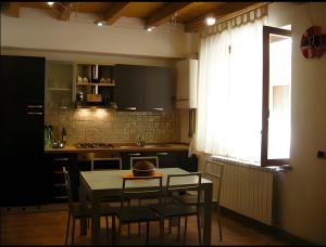 a kitchen with a table and chairs and a table and a window at A Ciciredda in Barrafranca +5 photos
