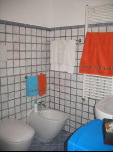 a bathroom with a sink and a toilet and towels at A Ciciredda in Barrafranca