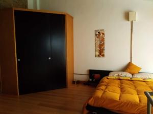 a bedroom with a bed and a black door at A Ciciredda in Barrafranca