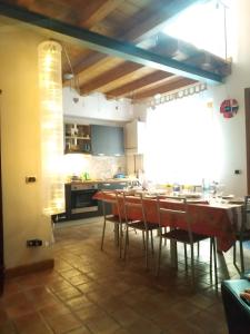 a kitchen and dining room with a table and chairs at A Ciciredda in Barrafranca