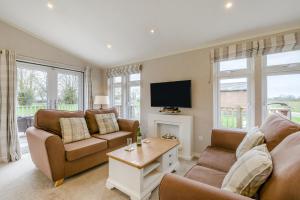a living room with two couches and a tv at Primrose 1 bed -No Pets-Rose in Eye