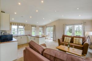 a living room with a couch and a table at Primrose 1 bed -No Pets-Rose in Eye
