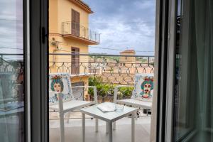a view of a balcony with two chairs and a table at Il Cortile Holiday House in Caccamo
