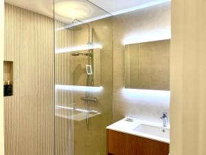 a bathroom with a shower and a sink at Hotel Le Fouquet's in Cannes +50 photos