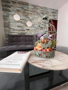 a bird cage filled with fruit on top of a table at OSHO Hotel in Santa Cruz de la Sierra