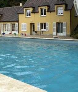 a large swimming pool in front of a house at Domaine de Thironne Lac & Nature in Montigny-le-Chartif
