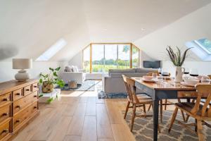 a living room with a table and a couch at The Roost in Wendling