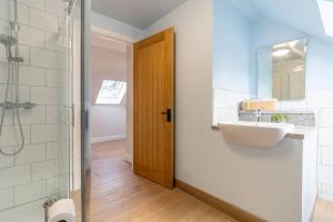 a bathroom with a sink and a shower at The Roost in Wendling +17 photos