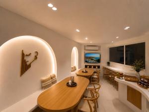 a kitchen and dining room with two tables and chairs at Dorkas Luxury Rooms&Apartments in Livadakia